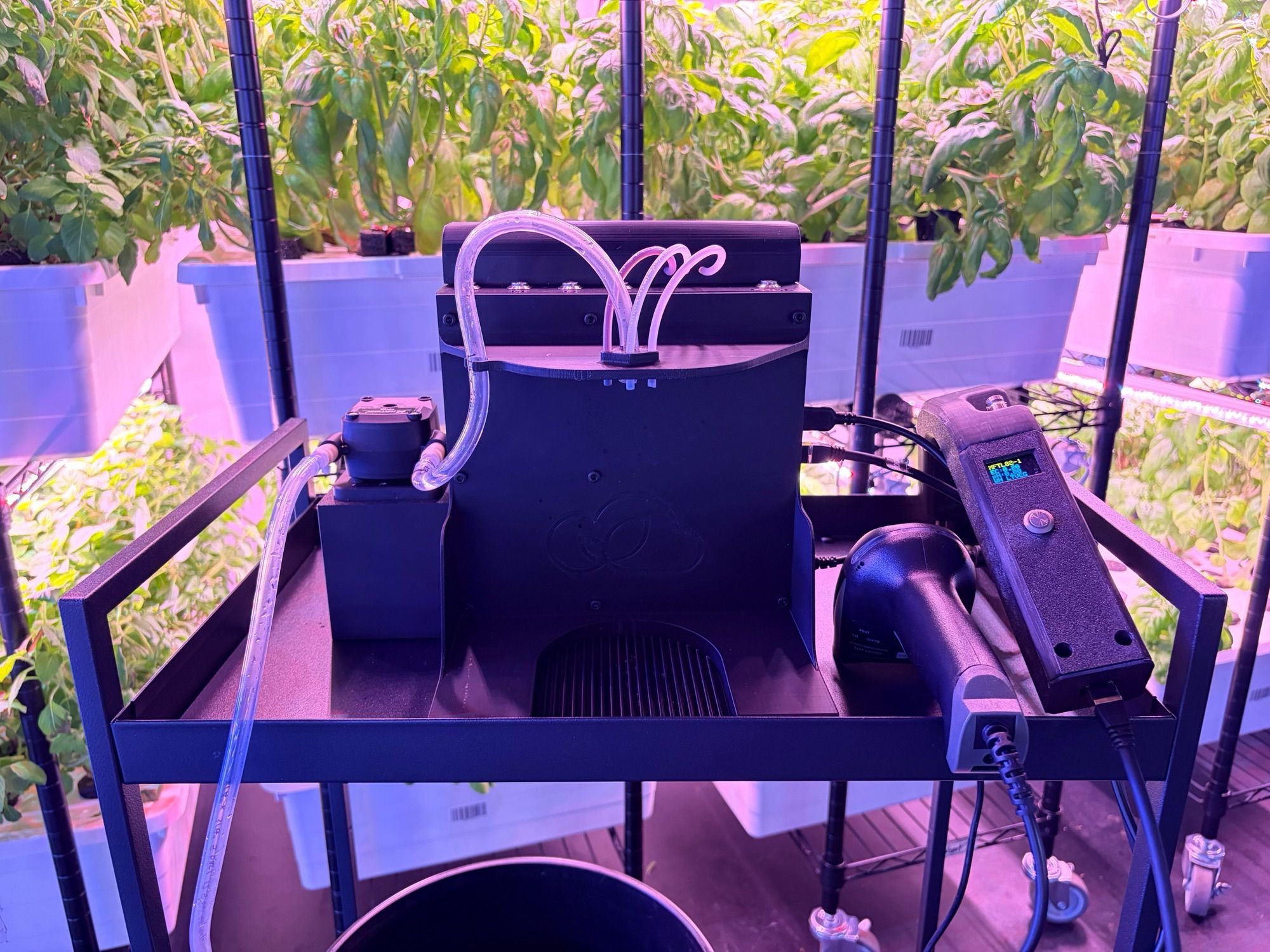 The SkyAcres robotic nutrient doser mounted on a rack